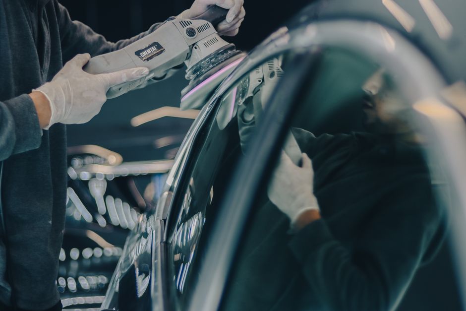 Professional auto detailing expert inspecting a clean vehicle